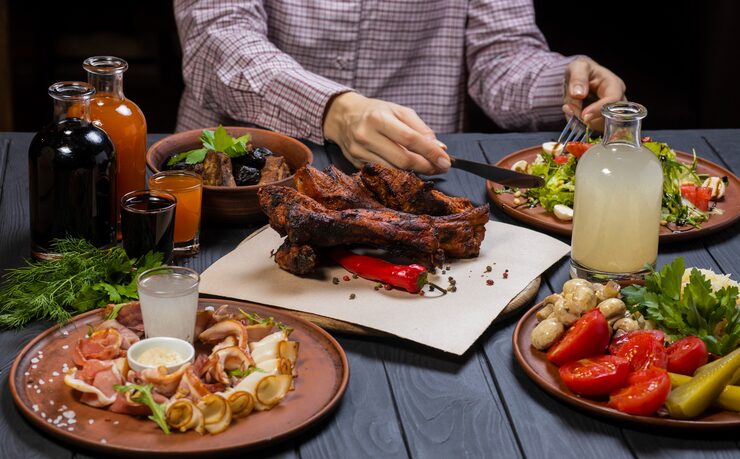 young-woman-shirt-black-gloves-begin-eating-fried-ribs-with-pepper-bottle-wine_281858-1512